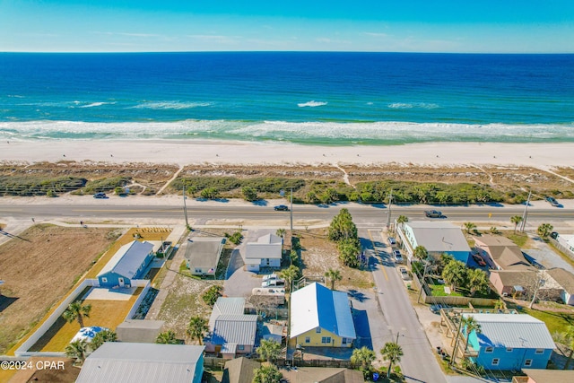 birds eye view of property with a water view and a view of the beach