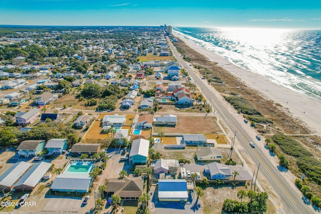 drone / aerial view featuring a water view and a beach view