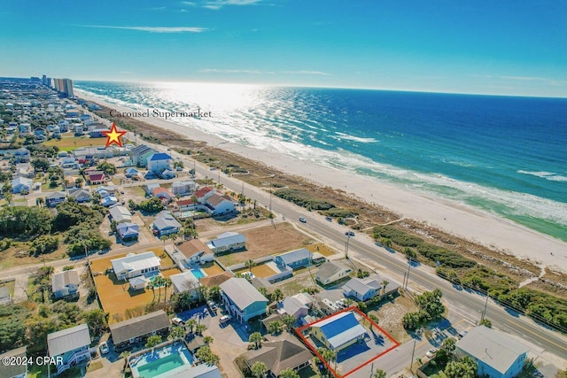 drone / aerial view with a water view and a view of the beach