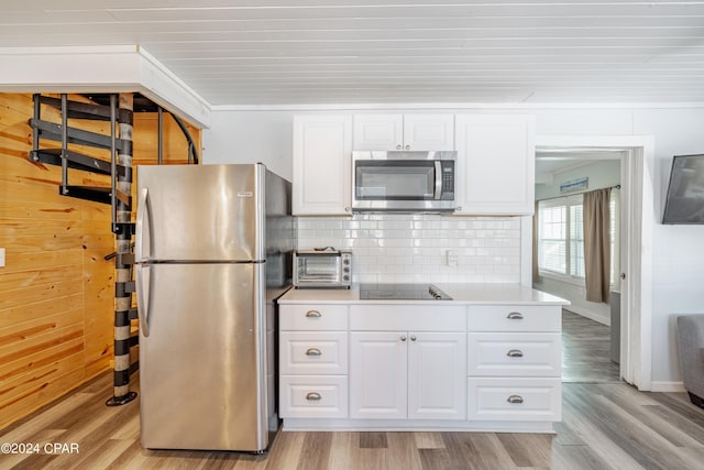 kitchen featuring white cabinetry, decorative backsplash, light hardwood / wood-style flooring, and stainless steel appliances