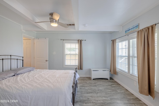 bedroom featuring ceiling fan, light hardwood / wood-style floors, and multiple windows