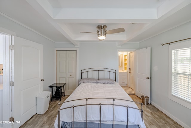 bedroom with beamed ceiling, light hardwood / wood-style floors, a closet, ceiling fan, and ensuite bathroom