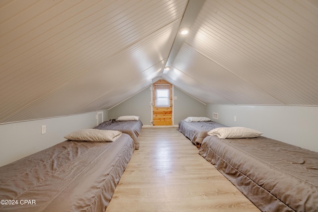 bedroom featuring light hardwood / wood-style floors and vaulted ceiling