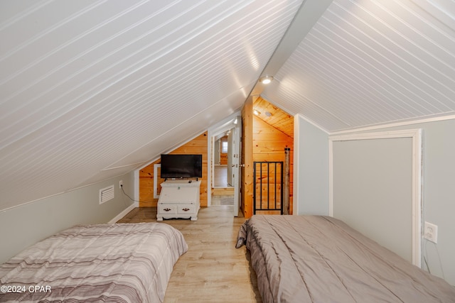 bedroom with light hardwood / wood-style flooring and lofted ceiling