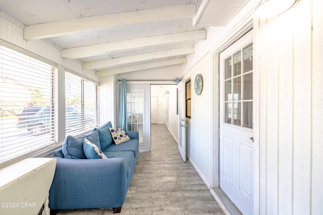 sunroom with vaulted ceiling with beams