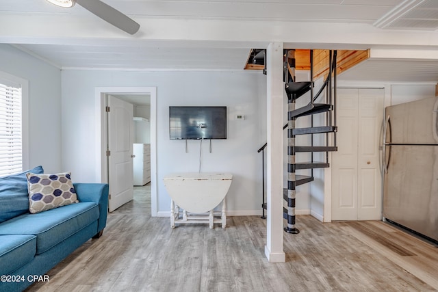 living room featuring ceiling fan and light hardwood / wood-style flooring