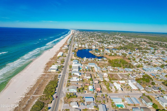 bird's eye view with a water view and a beach view