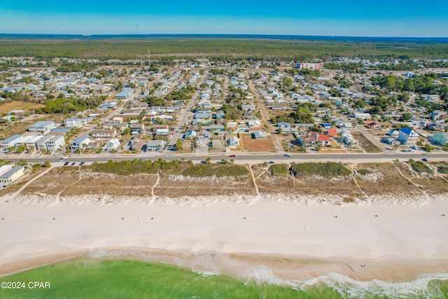 birds eye view of property with a beach view and a water view