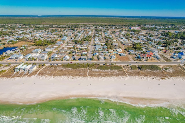 birds eye view of property featuring a water view and a beach view