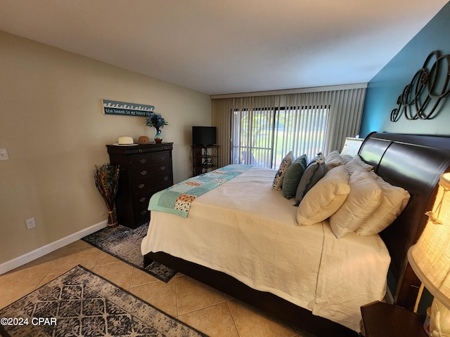 tiled bedroom featuring ensuite bath