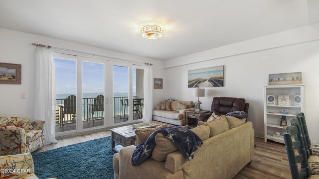 living room with wood-type flooring and a water view