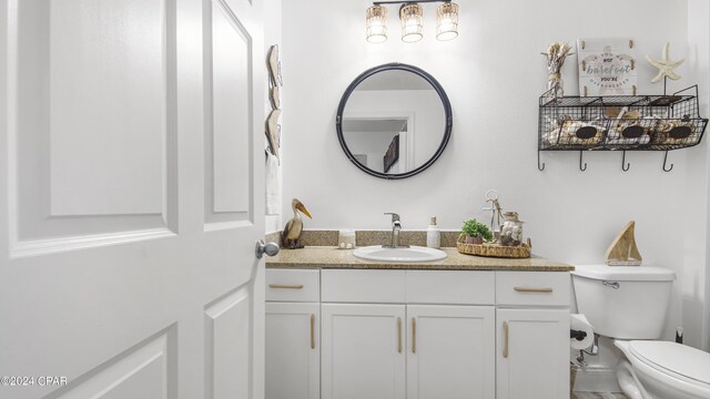 bathroom with toilet and vanity