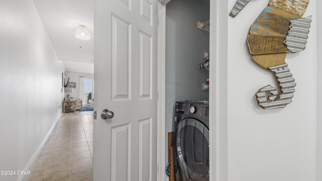 clothes washing area featuring light tile patterned floors and washer / dryer