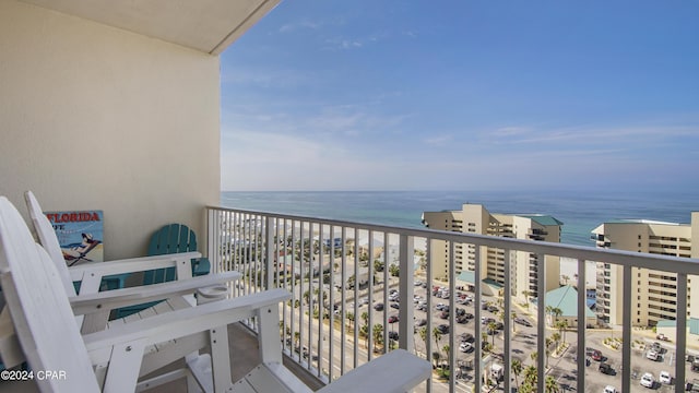 balcony featuring a water view and a view of the beach