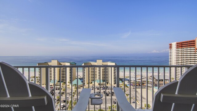 balcony featuring a water view and a beach view