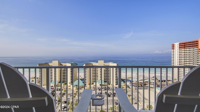 balcony with a water view and a beach view