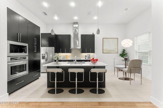3502 Fox Run Blvd, Panama City, FL 32408 - kitchen with appliances with stainless steel finishes, dark cabinets, light countertops, a kitchen bar, and baseboards