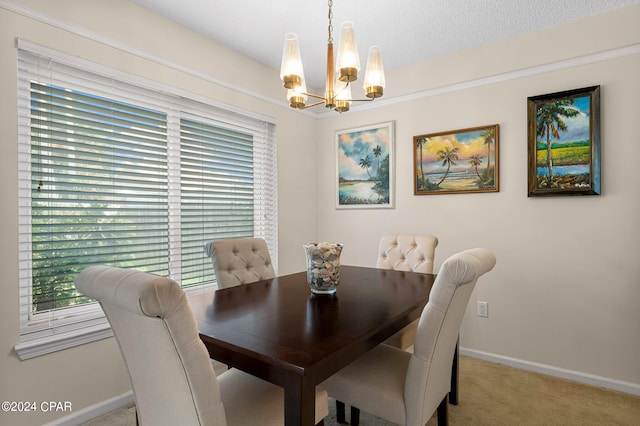 carpeted dining room featuring a notable chandelier and a textured ceiling