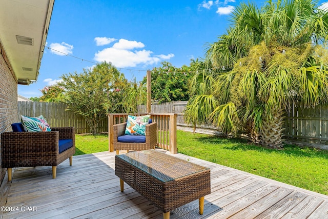 deck with outdoor lounge area and a lawn