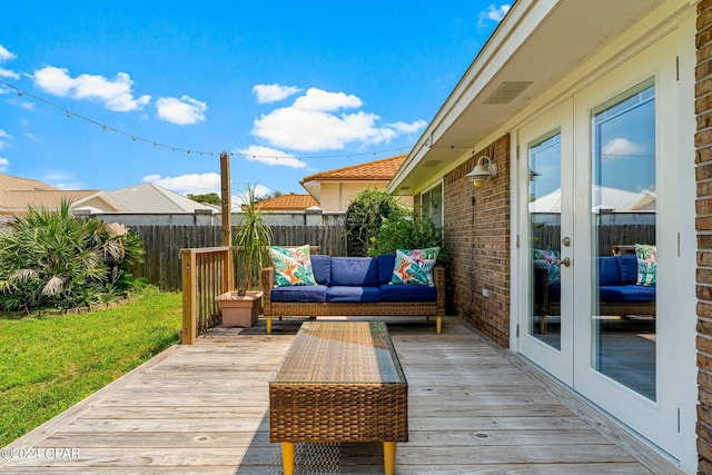 wooden deck featuring french doors and an outdoor living space