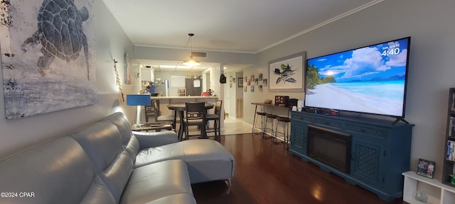 living room with ornamental molding and dark wood-type flooring