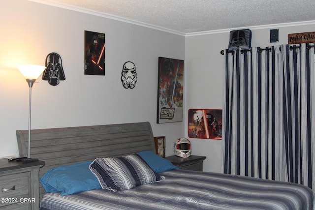 bedroom featuring ornamental molding and a textured ceiling