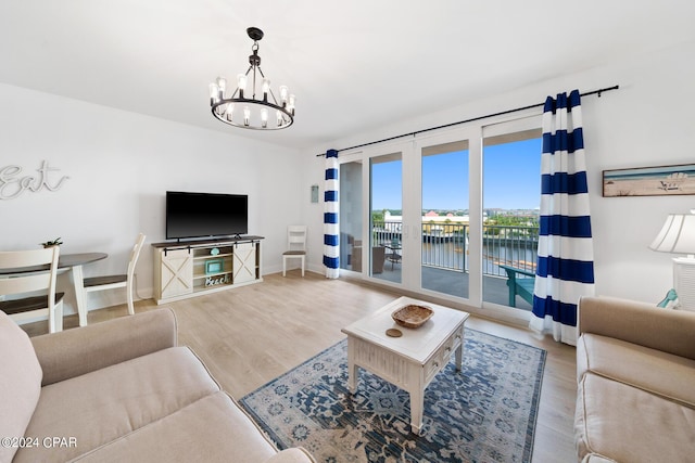 living room with hardwood / wood-style floors and an inviting chandelier