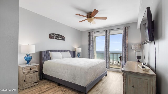 bedroom with ceiling fan, light hardwood / wood-style floors, and access to exterior