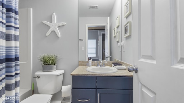 bathroom with visible vents, toilet, and vanity