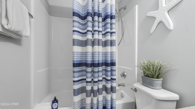 full bath with shower / bath combo with shower curtain and toilet