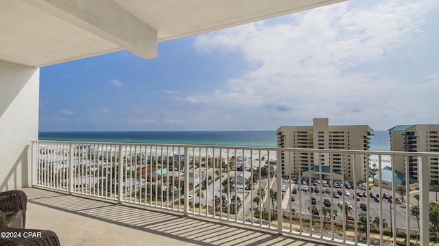 balcony with a water view and a beach view
