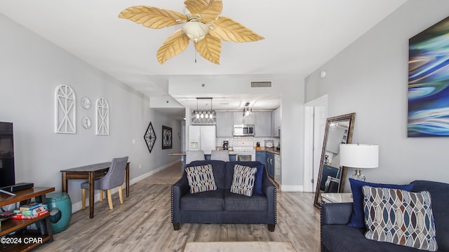 living room with ceiling fan and hardwood / wood-style floors