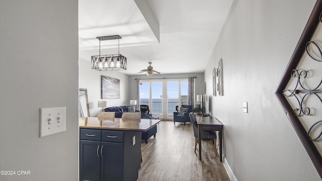 kitchen with baseboards, open floor plan, decorative light fixtures, dark wood finished floors, and ceiling fan