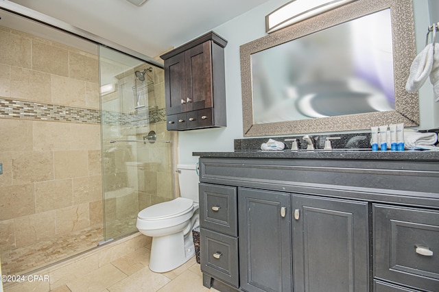 bathroom featuring vanity, toilet, and walk in shower