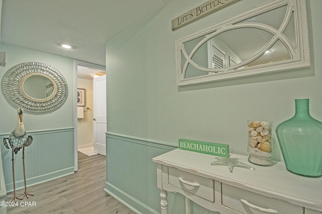 hallway with light hardwood / wood-style floors