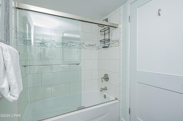 bathroom featuring combined bath / shower with glass door