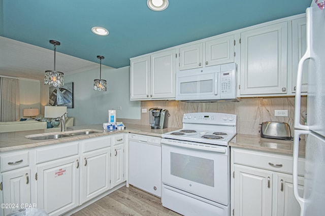 kitchen featuring pendant lighting, sink, white appliances, and white cabinets