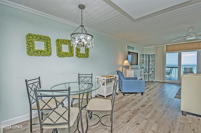 dining room with ornamental molding, a water view, ceiling fan with notable chandelier, and light hardwood / wood-style floors