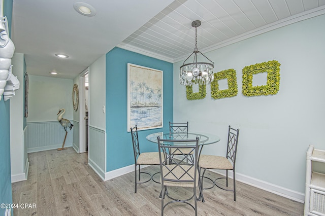 dining space featuring a chandelier and light wood-type flooring