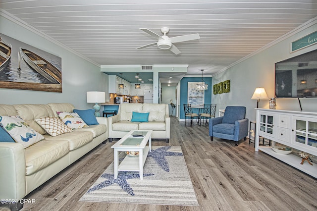 living room featuring crown molding, hardwood / wood-style floors, and ceiling fan