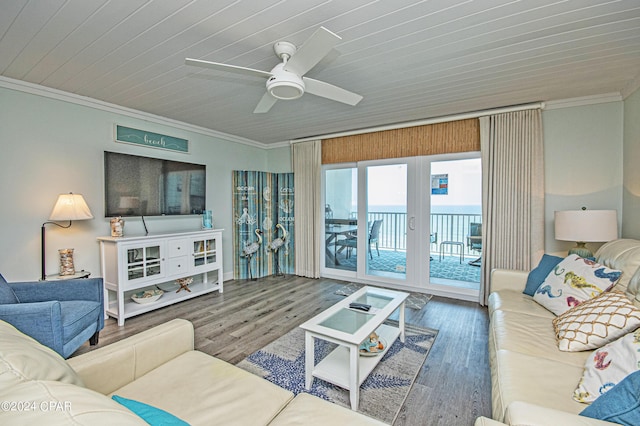 living room featuring wood-type flooring, ornamental molding, and ceiling fan