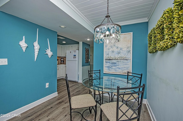 dining space with an inviting chandelier and light hardwood / wood-style flooring