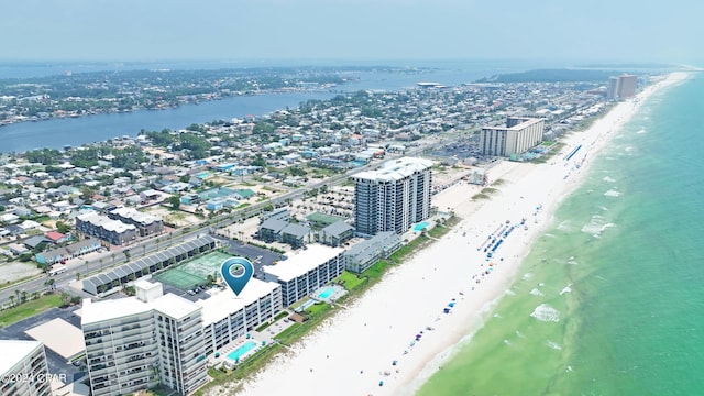 drone / aerial view featuring a water view and a beach view