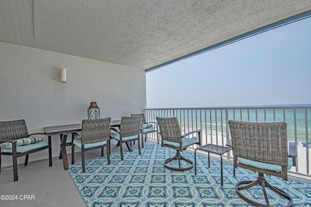 view of patio with a water view and a balcony