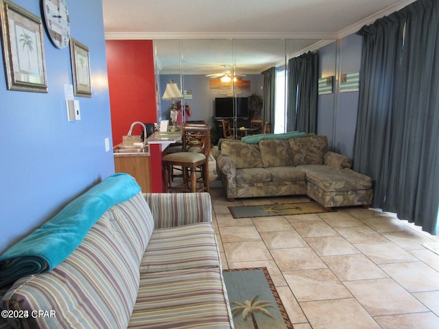 tiled living room with sink, ornamental molding, and ceiling fan