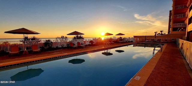 pool at dusk with a water view