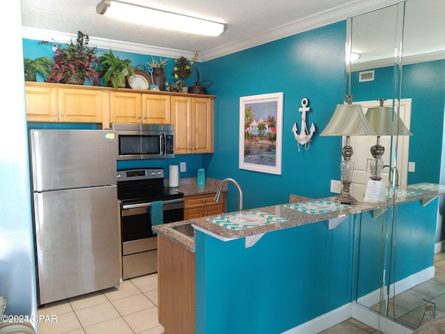 kitchen featuring a breakfast bar area, stainless steel appliances, ornamental molding, light tile patterned flooring, and light brown cabinets