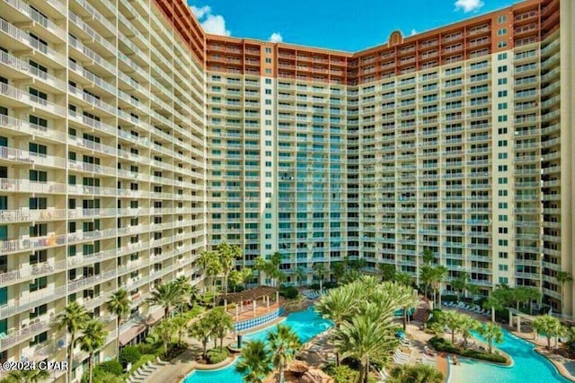 view of building exterior featuring a community pool