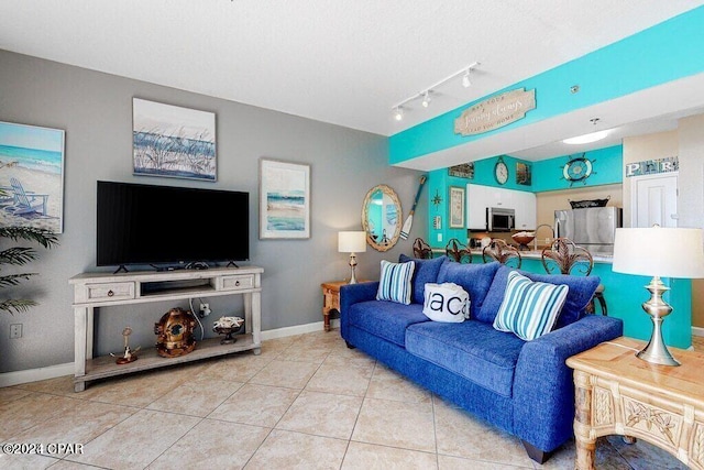 tiled living room with sink and track lighting