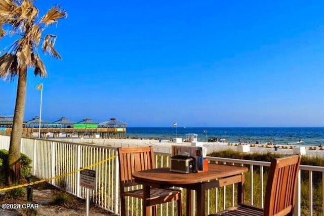 deck featuring a water view and a view of the beach